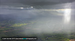 backlit rain showers over Cashel. Galty Mountains